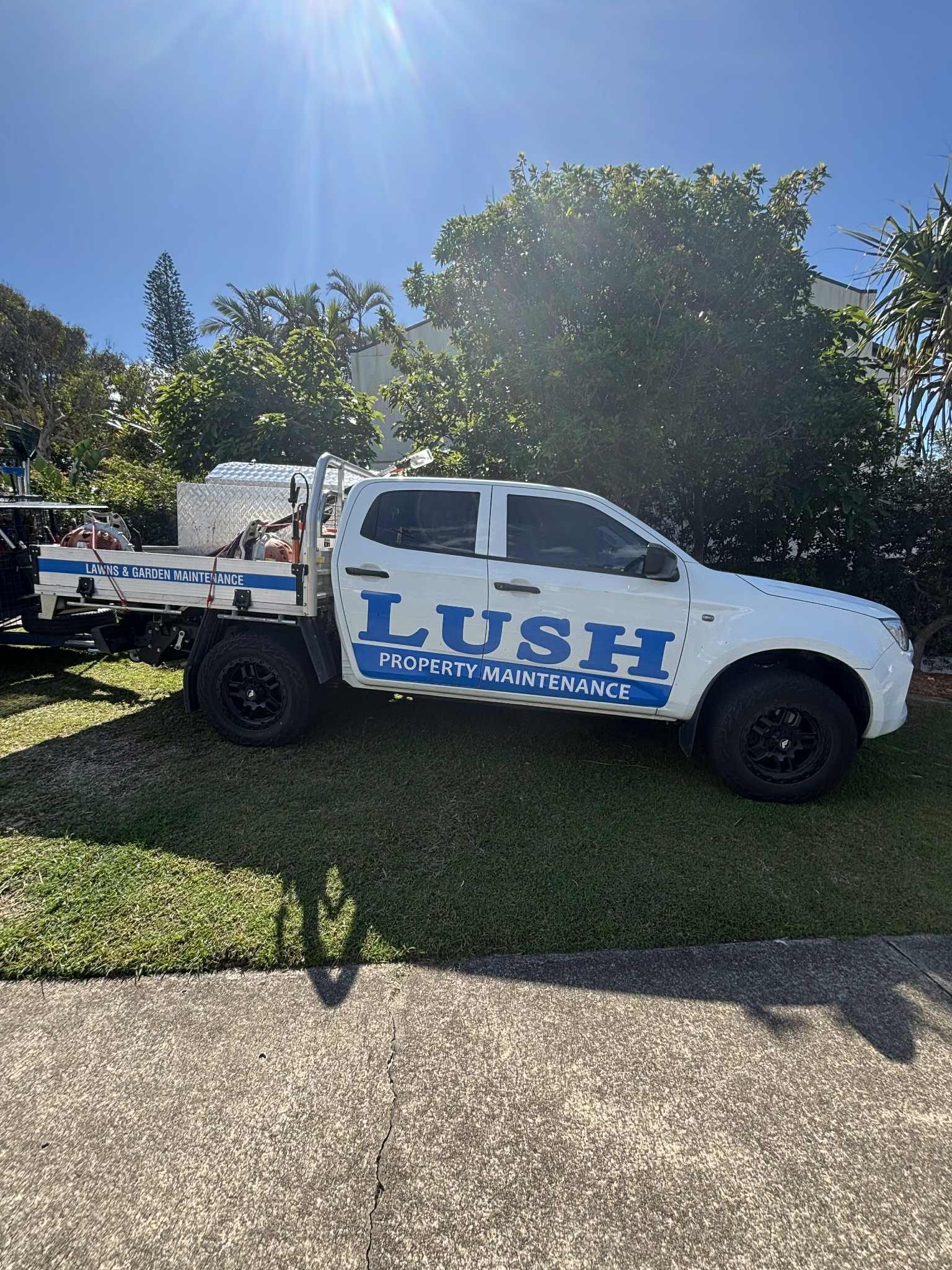 A Man Wearing A Hat Is Installing A Screen Door — Lush Property Maintenance Noosa In Noosa Heads, QLD