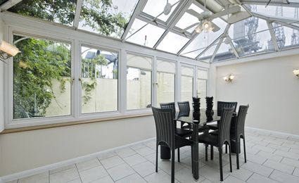 large white conservatory interior with black table and chairs