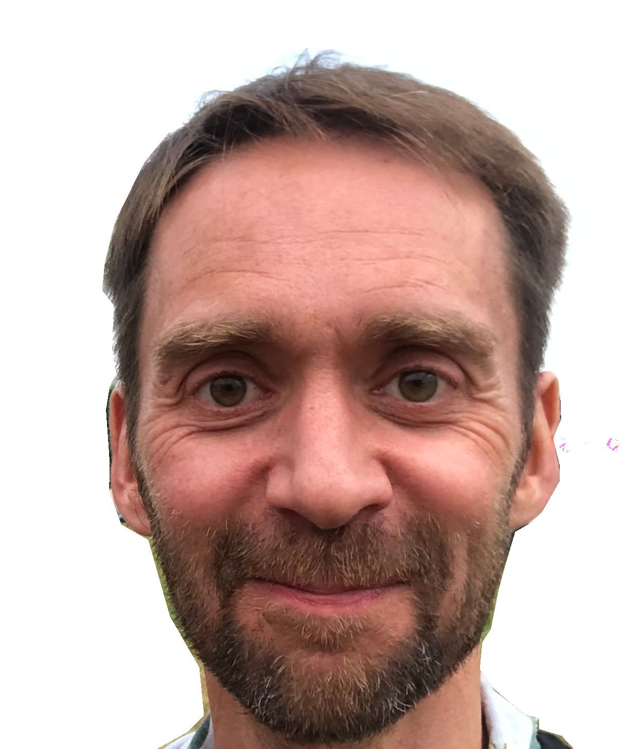 A man with a beard is smiling for the camera.