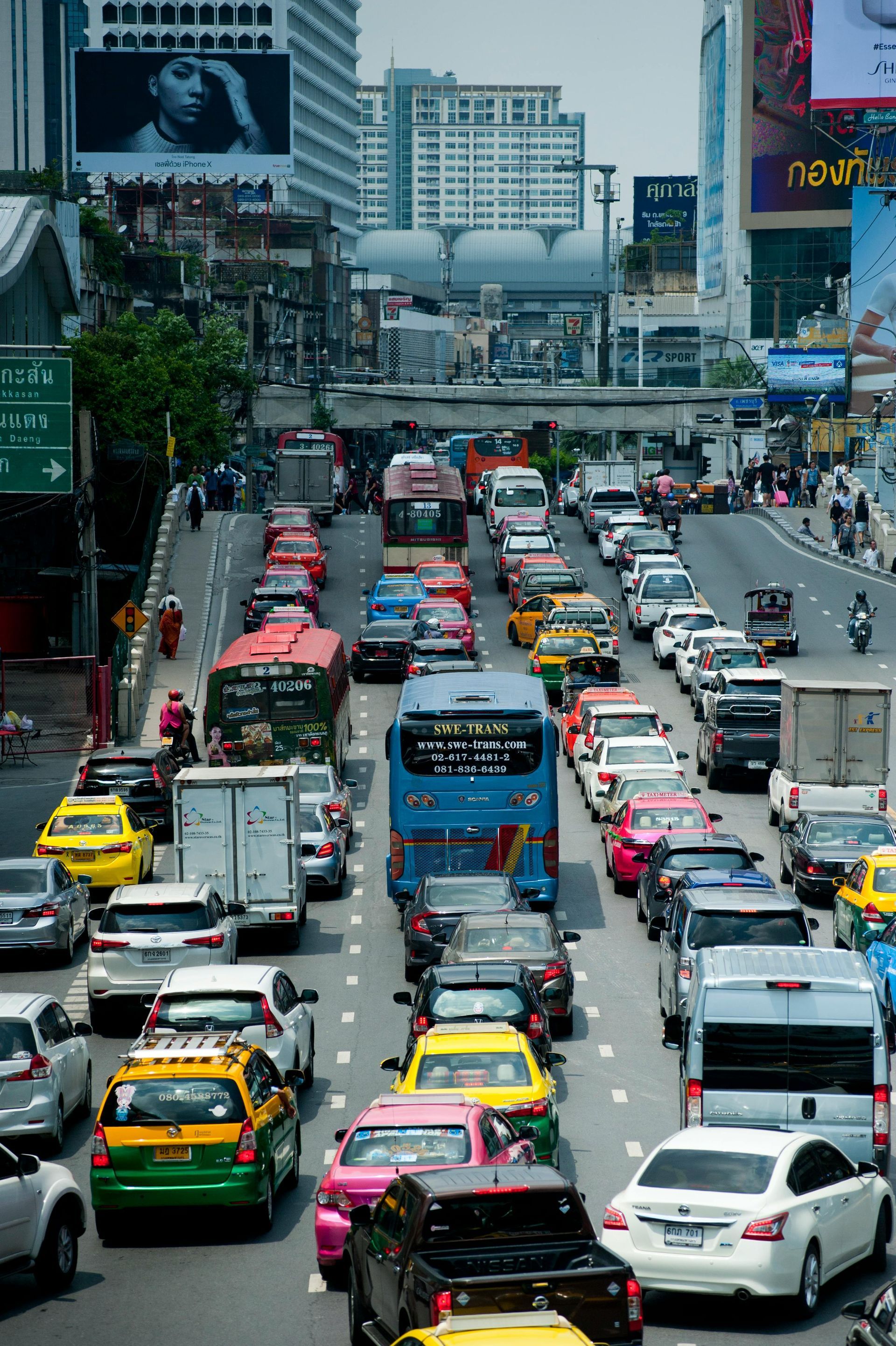 A lot of vehicles are driving along a congested urban highway.