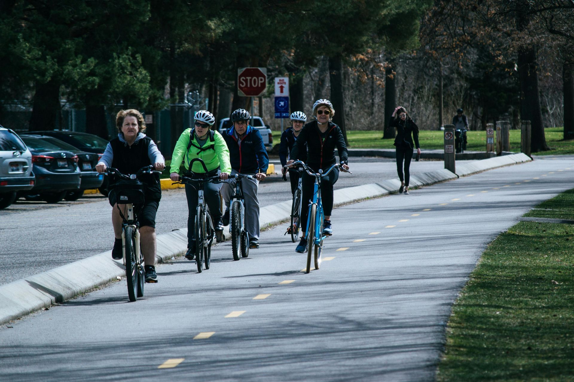 A group of people are riding bicycles down a street.