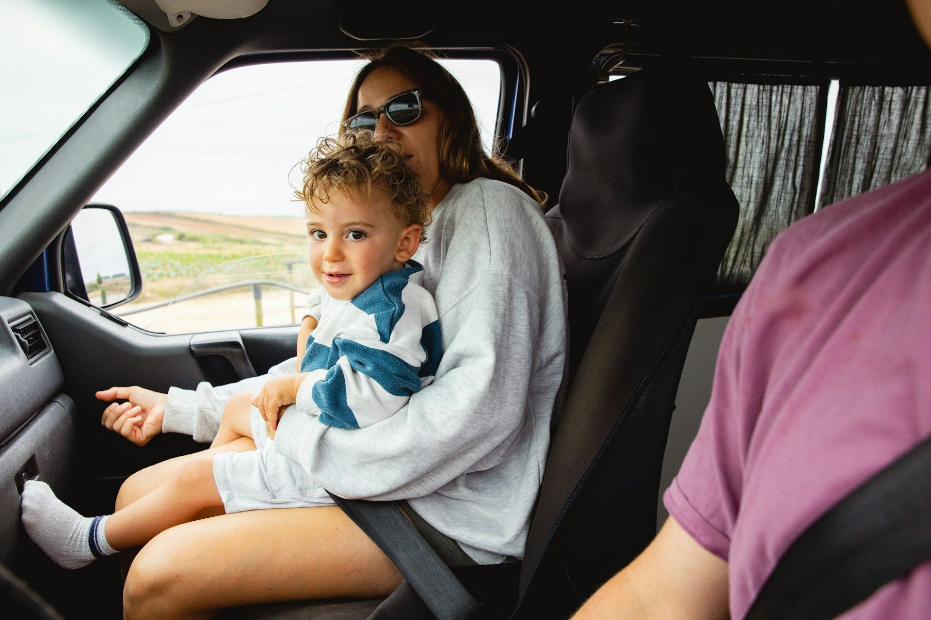 Person holding scales of justice, gavel on table, legal setting.