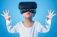 A young girl is wearing a virtual reality headset.