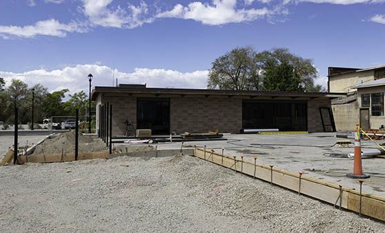 A house is being built in the middle of a dirt field.