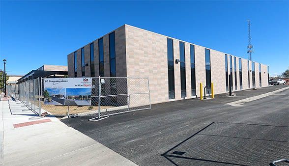 A large building with a fence around it is under construction.