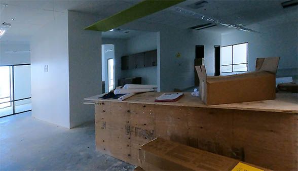 An empty room with a wooden counter and boxes on it