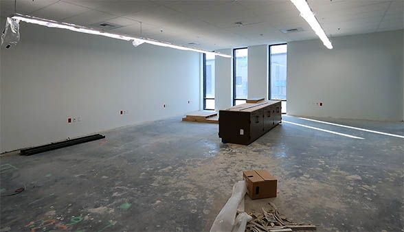 A large empty room with a table in the middle of it.