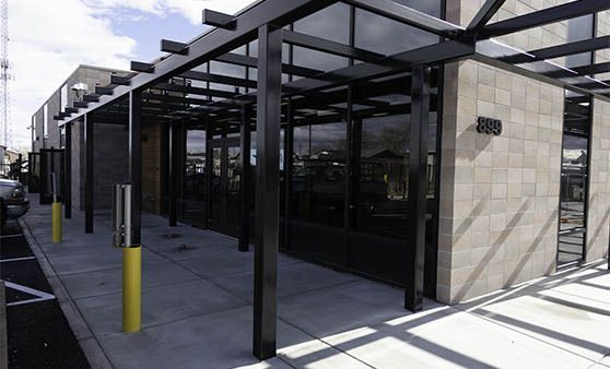 A building with a lot of windows and a covered walkway.
