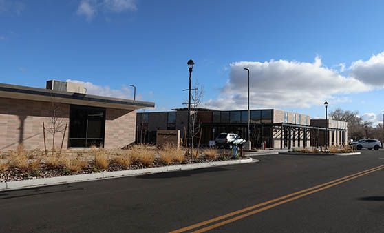 A group of buildings are sitting next to each other on the side of a road.