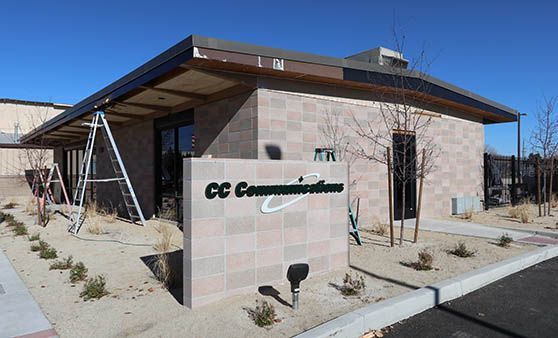 A building with a sign that says cc communications on it.