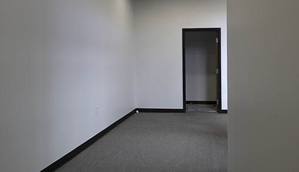 An empty room with a door in the middle of it.