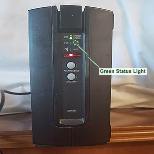 A black ups that has a green status light on it