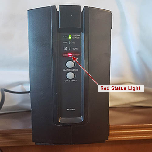 A black ups with a red status light on it