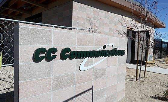 A building with a sign that says cc communications on it