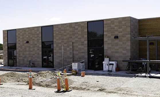 A large brick building with a lot of windows is being built.
