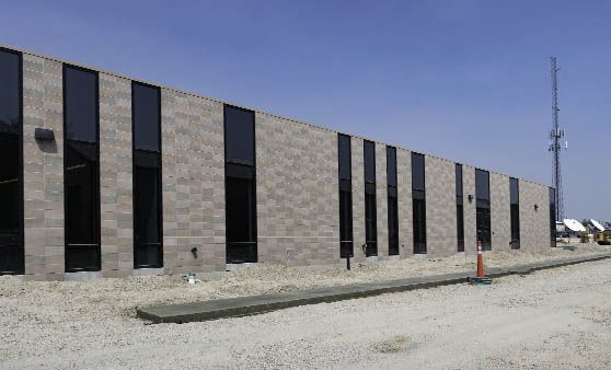 A large brick building with a lot of windows is being built.