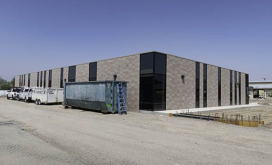 A large brick building with a lot of windows is being built.