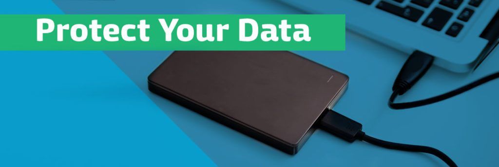 A hard drive is plugged into a laptop computer.