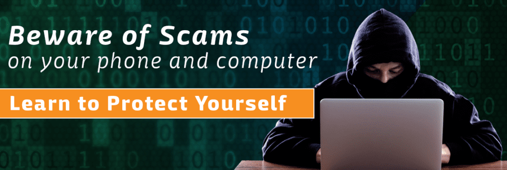 A man in a hood is sitting in front of a laptop with the words beware of scams on your phone and computer below him