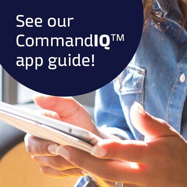 A woman is holding a cell phone with the words see our commandiq app guide