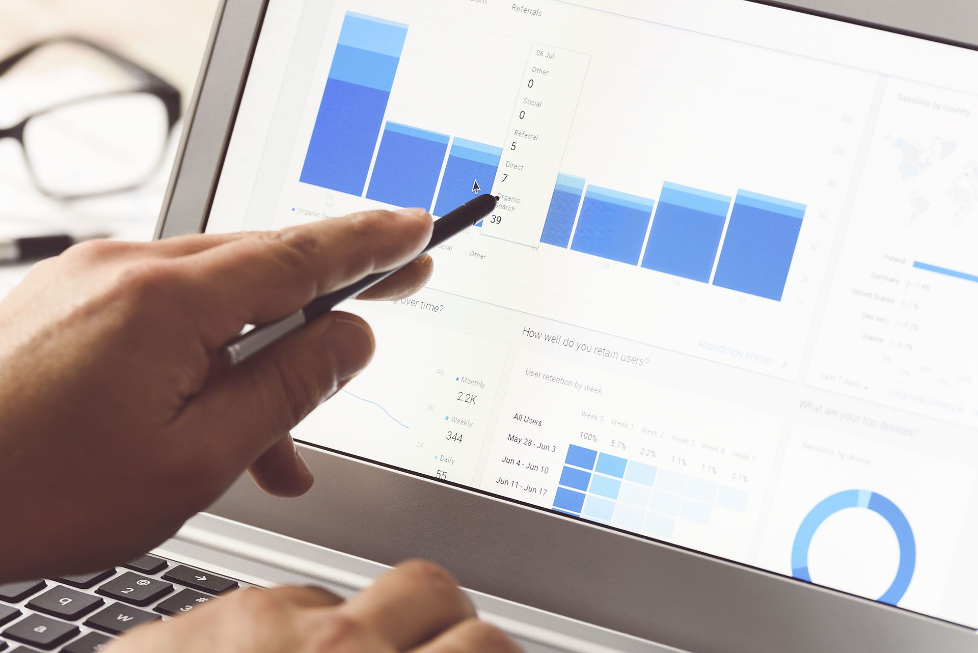 Businessman using internet analytics in the office on the touch screen of his laptop (reduced tone)