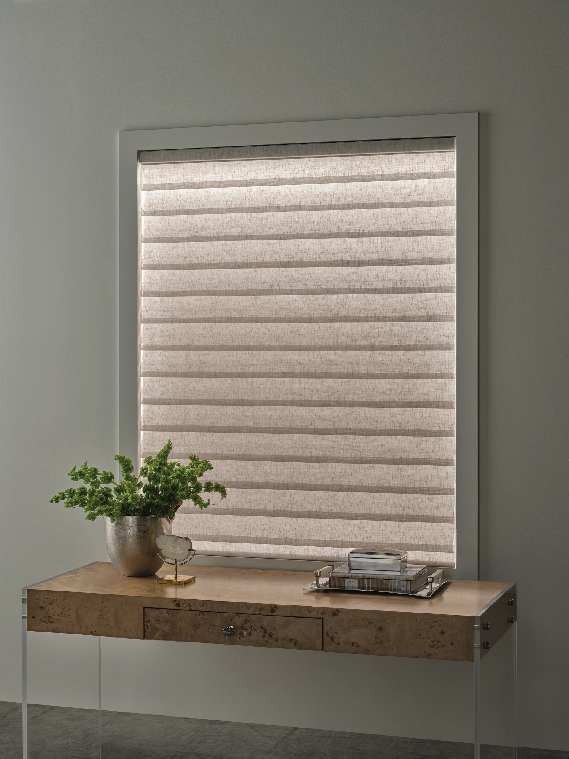 Hunter Douglas Aura Illuminated sheer shades showing soft LED backlighting in a modern home
