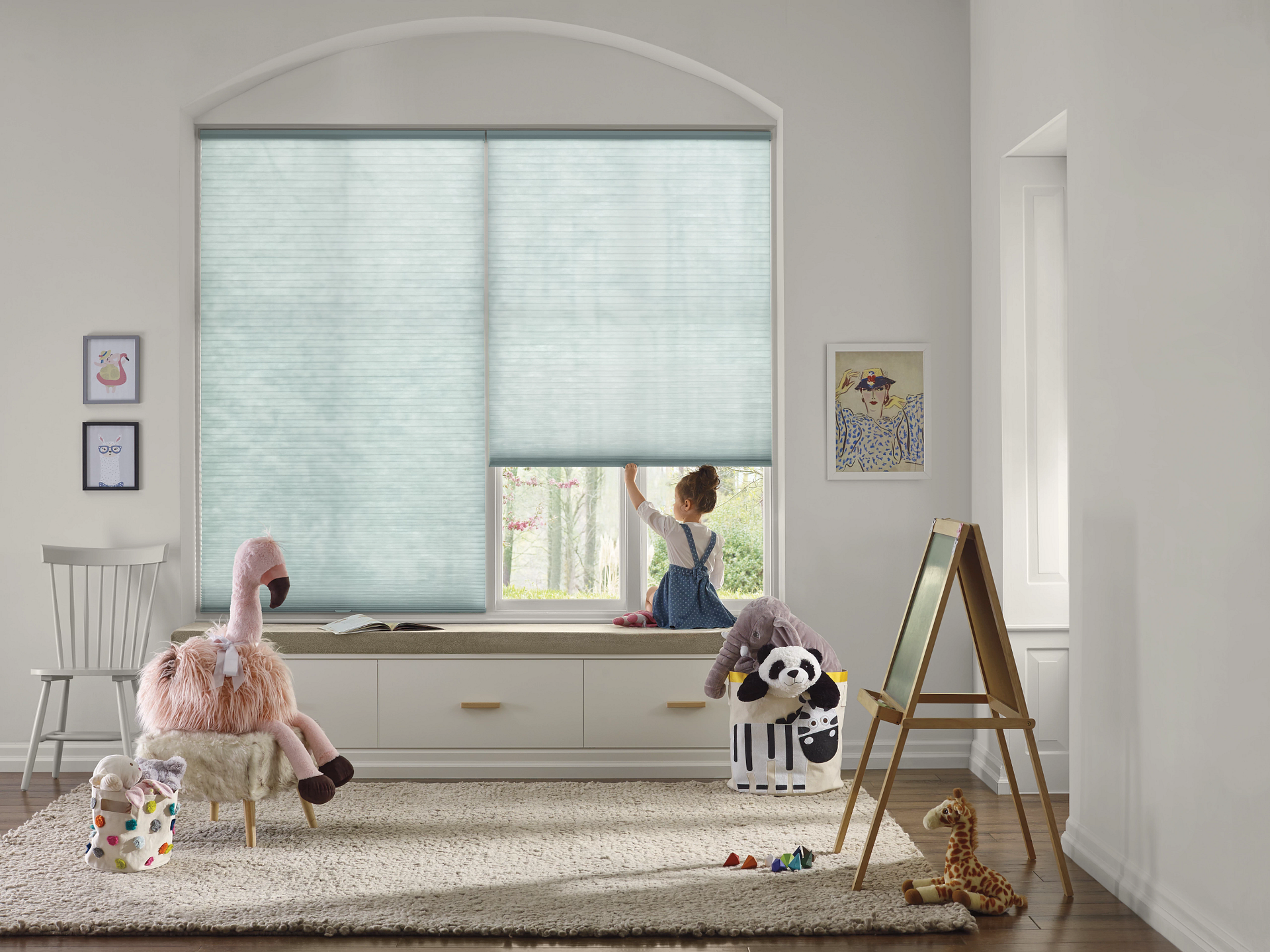 Child sitting by a window with Hunter Douglas Applause® Honeycomb Shades, showcasing energy-efficien