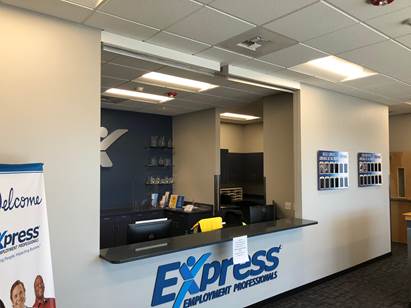 The reception area of an Express Employment Professionals office, featuring a service counter and brand signage.