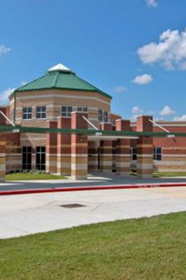 a large brick building with a green roof