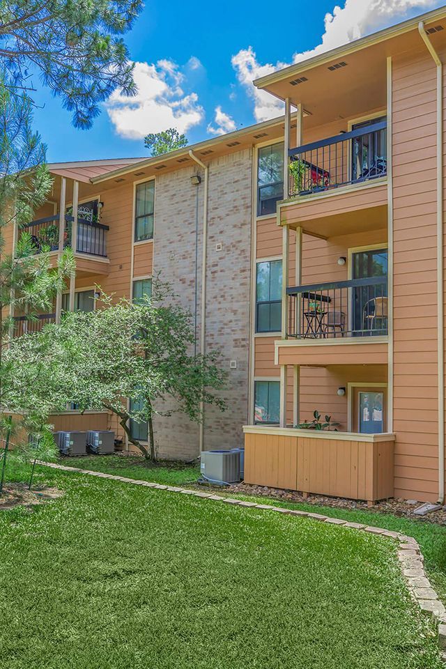 a large apartment building with a lot of windows and balconies .