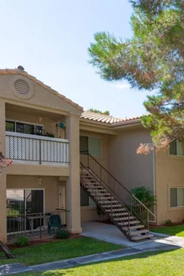 a large apartment building with stairs leading up to the second floor .