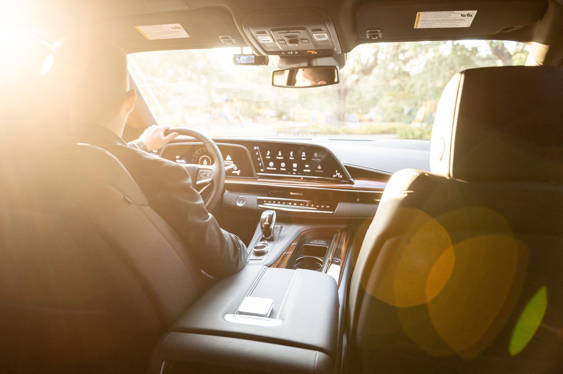 Private jet on tarmac with black SUV under a blue sky.