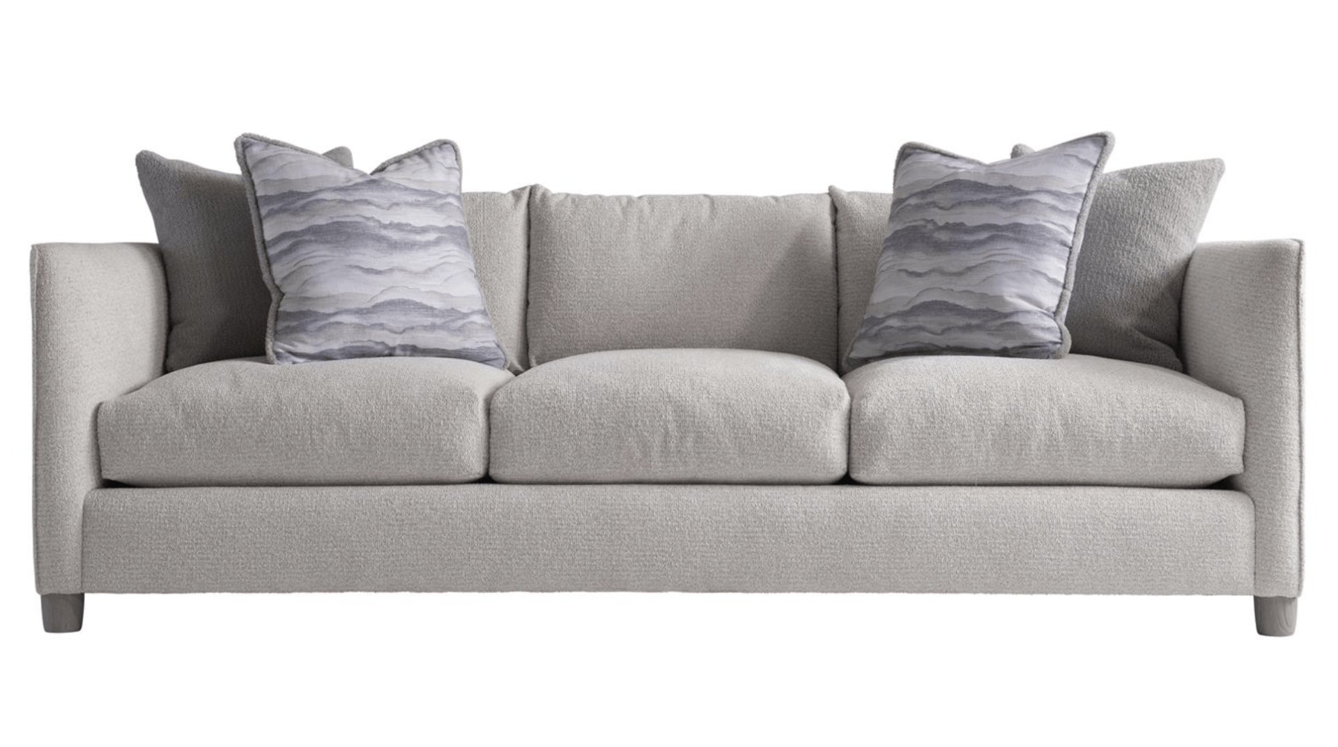 a grey couch with two pillows on it on a white background .