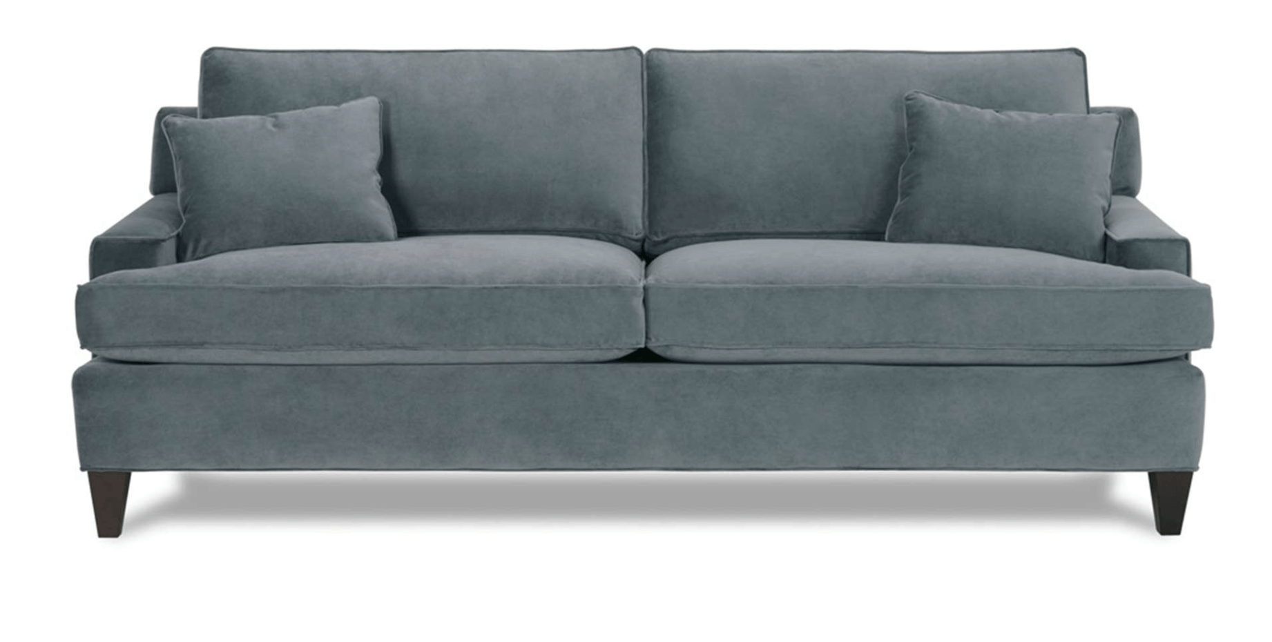 a blue couch with two pillows on it on a white background