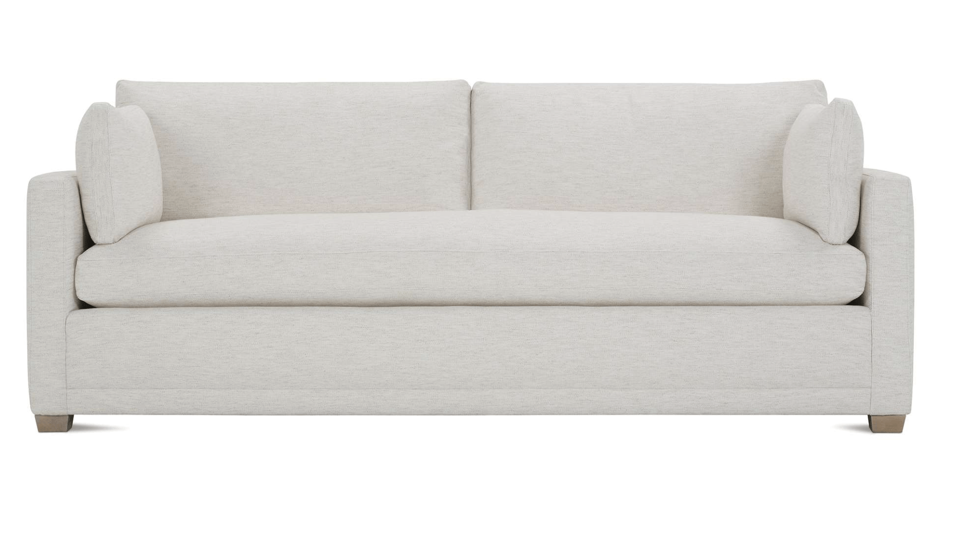 a white couch with two pillows on a white background .