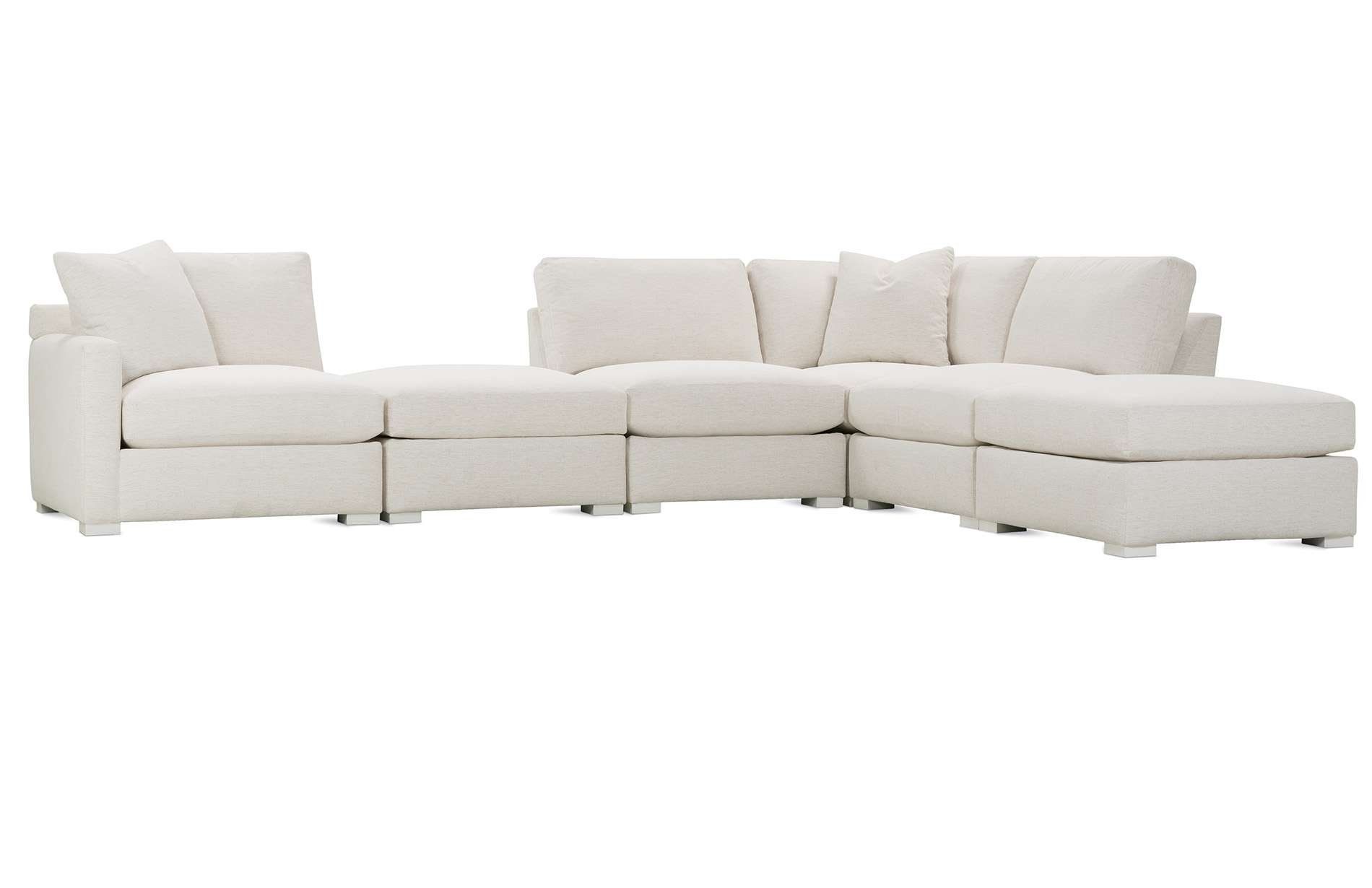 a white sectional couch with a chaise lounge on a white background .