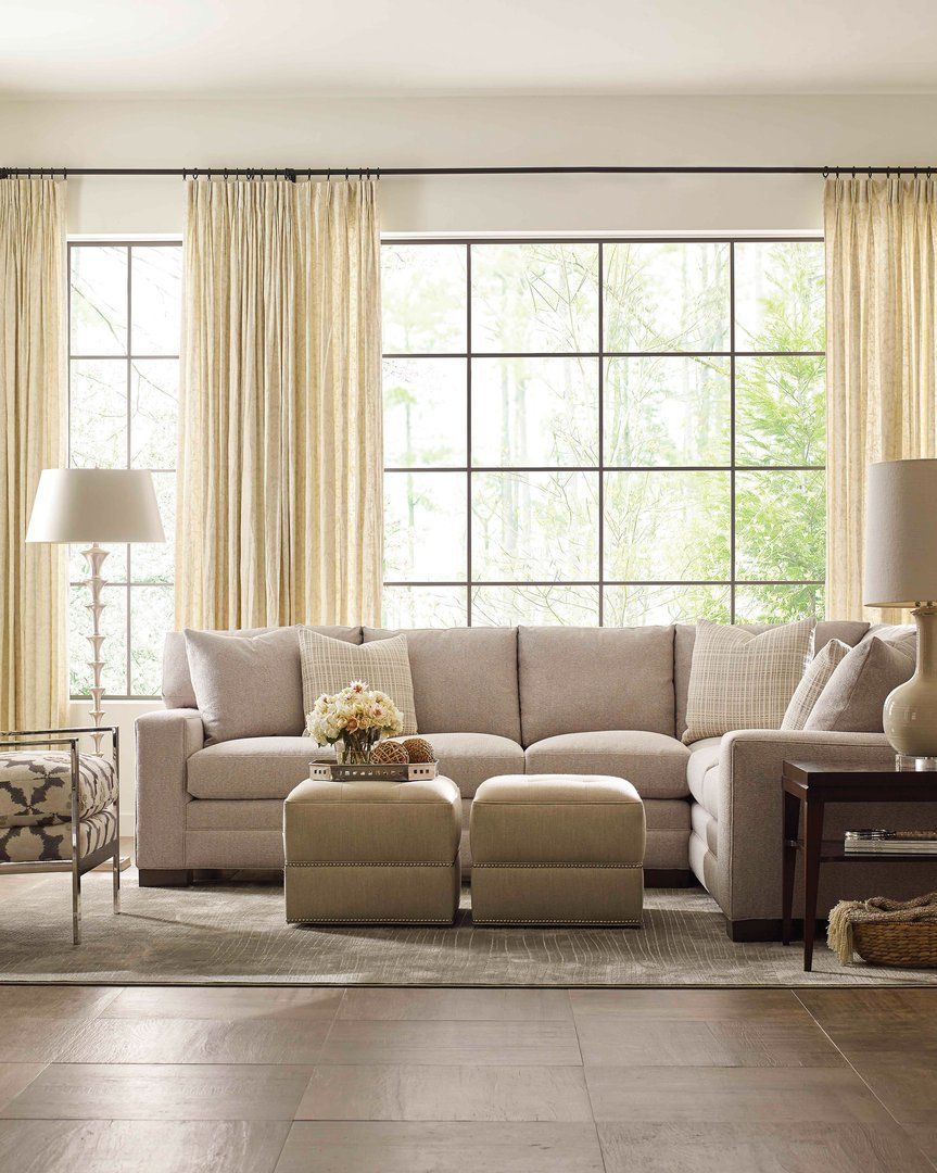 a living room filled with furniture and a large window .