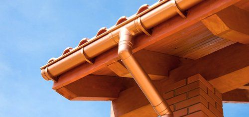 copper gutter pipe on home