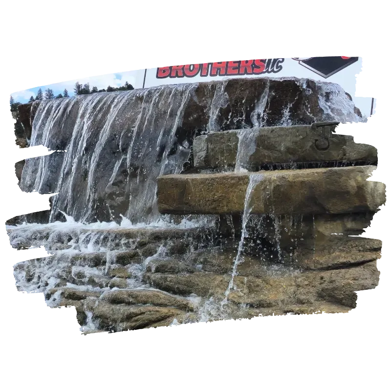 Waterfall cascading over tiered stone structure with 