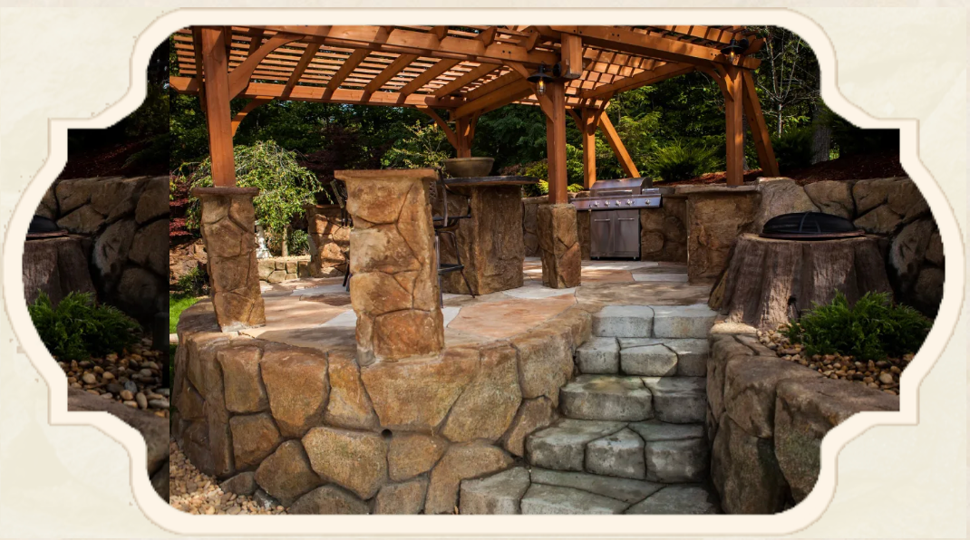 Stone patio with pergola, built-in grill, and steps. Surrounded by stone walls and landscaping.