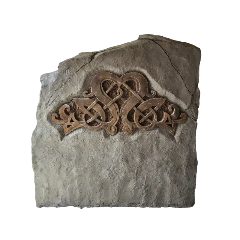 Stone slab with Celtic knot design carved in gold.