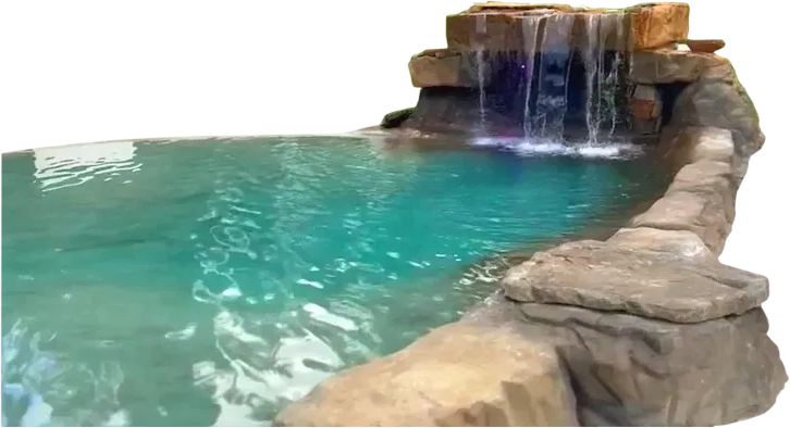 Artificial waterfall cascading into a turquoise-colored pool with rocky border.