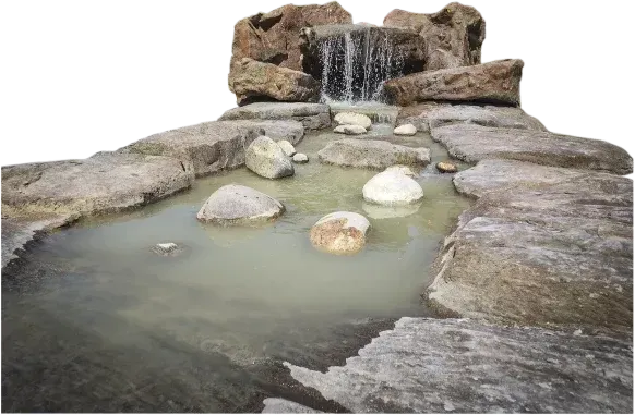 Waterfall feature with rocky ledges and pond, water cascading down.