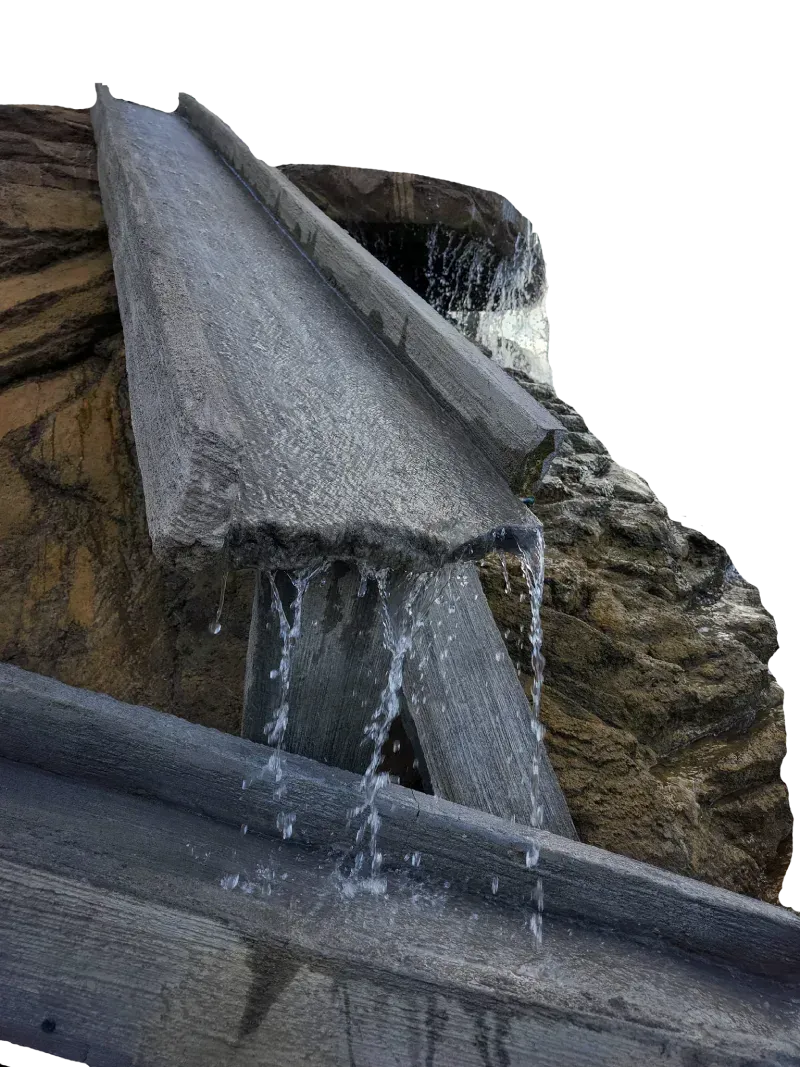 Water flows down a stone-like fountain feature.