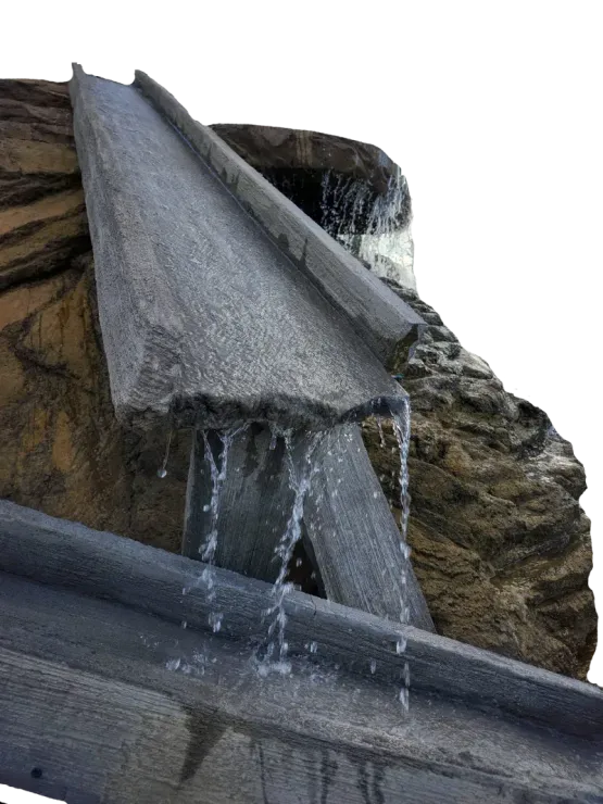 Water flows down a stone-like fountain feature.
