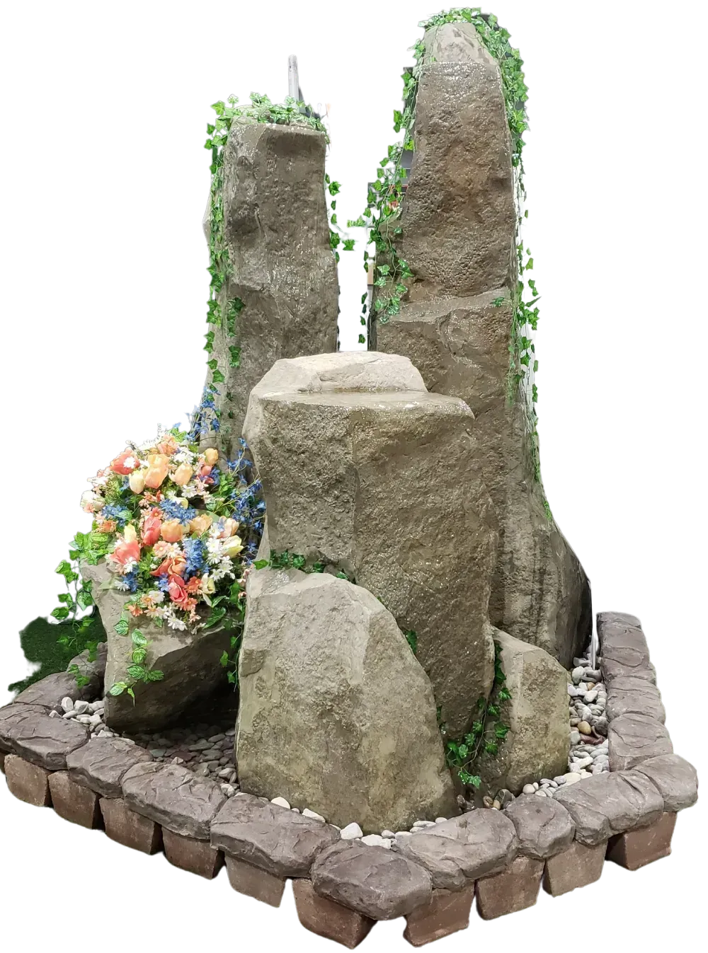 Rock fountain with faux ivy, flowers, and cobblestone base.