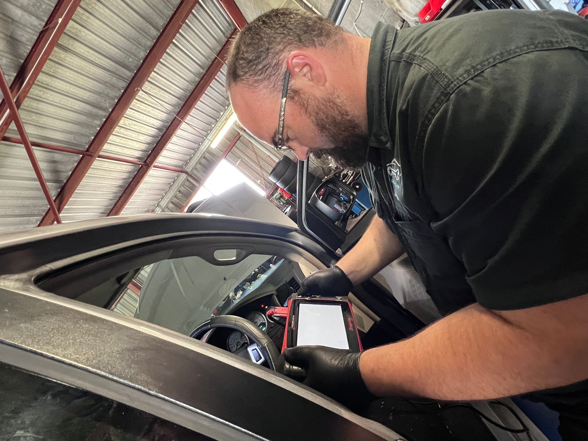 Man Inspecting the Car Diagnostics — Joe’s Auto Service Centre in Forster, NSW