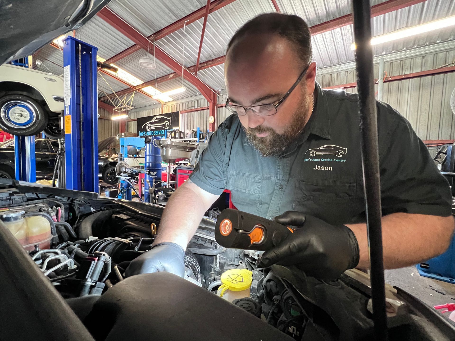Mechanic Checking Under Car — Joe’s Auto Service Centre in Forster, NSW