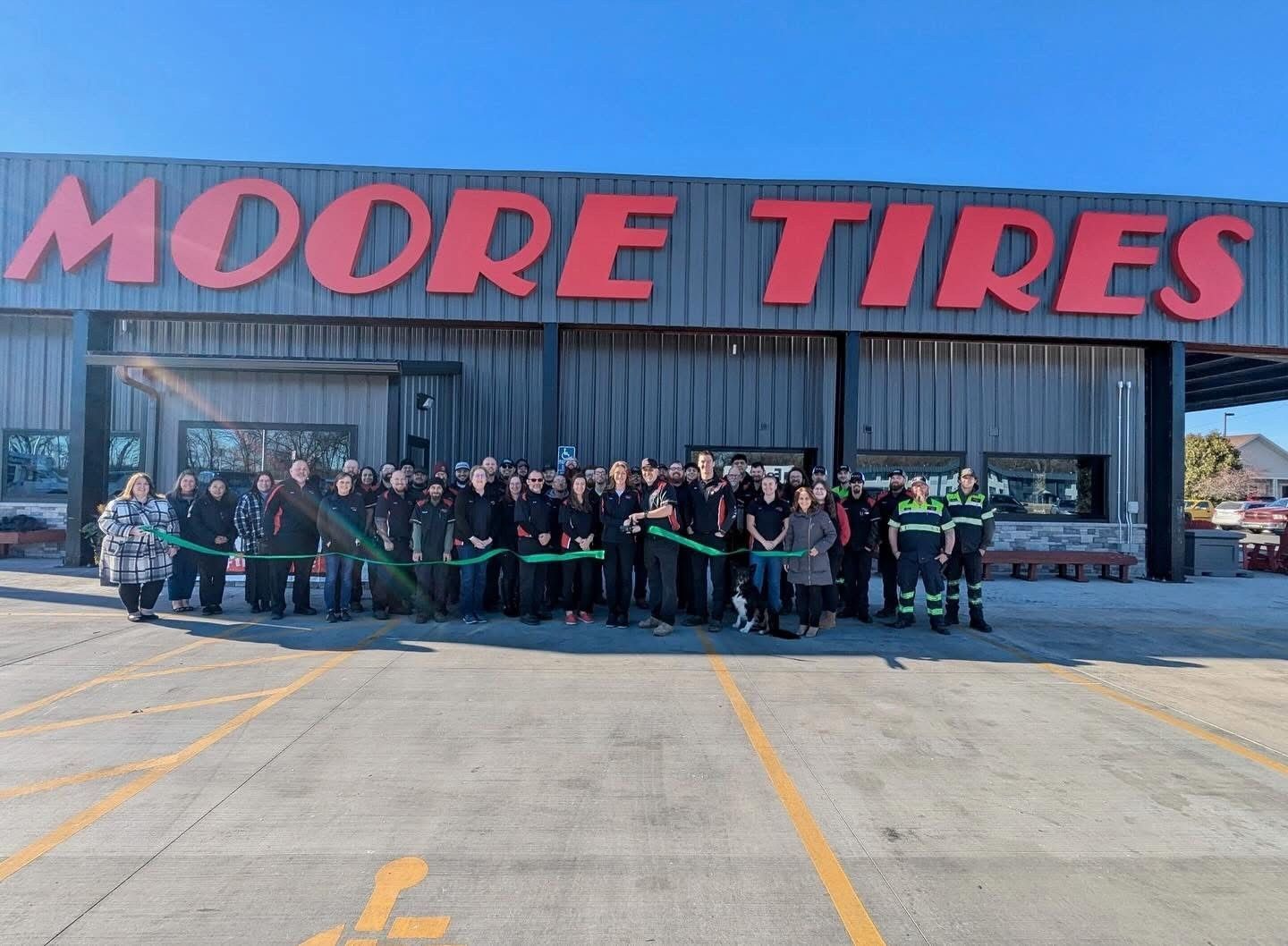 People cutting a ribbon in front of 