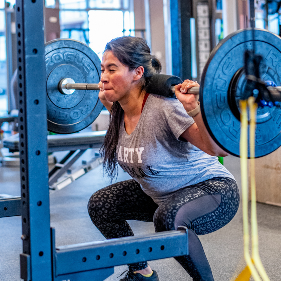 Brickz Fitness member squatting